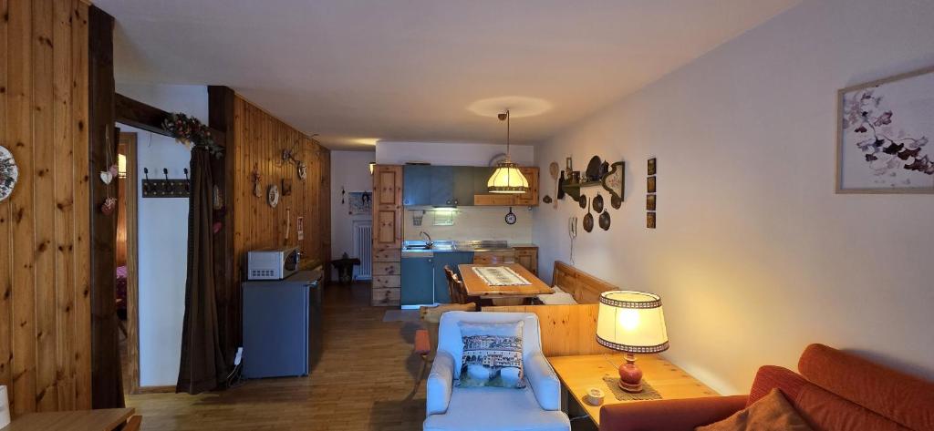 a living room with a couch and a table at Casa Vaiolet in Pozza di Fassa