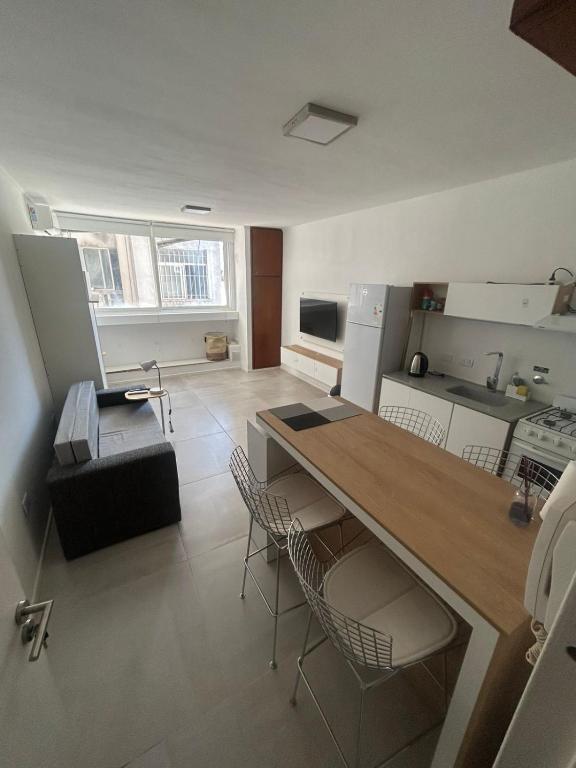 a kitchen with a table and chairs in a room at Espacio Centro in La Plata