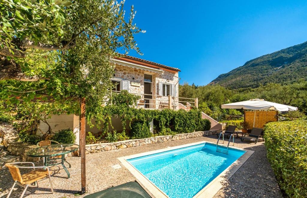 a villa with a swimming pool and a house at Amalthia Cottage in Vathi, Ithaka