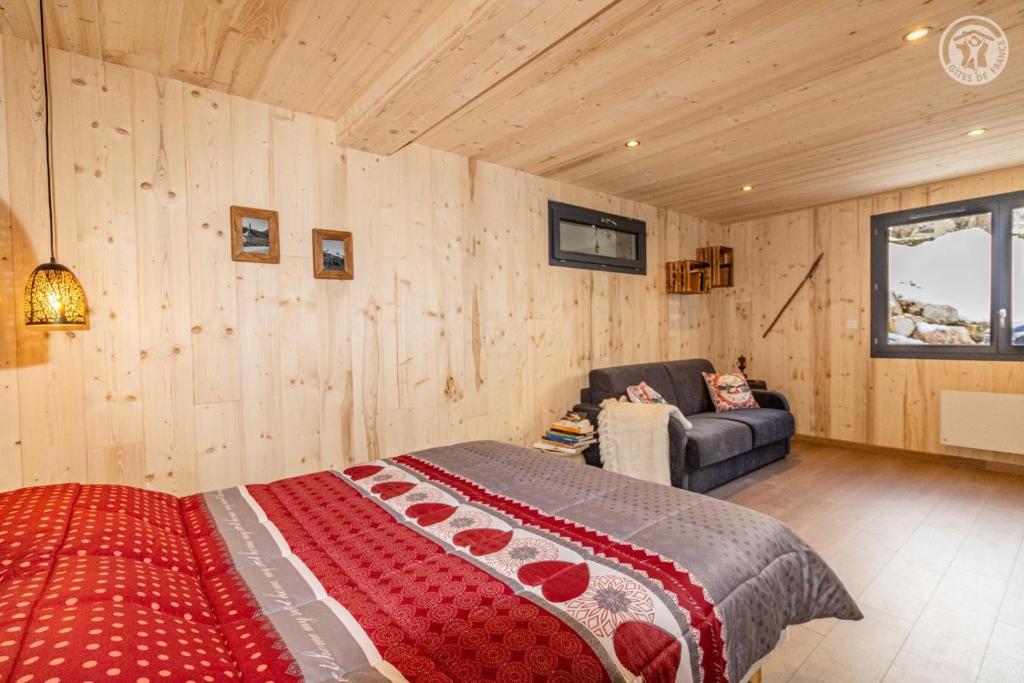 a bedroom with a bed and a couch at Romy in Aillon-le-Jeune