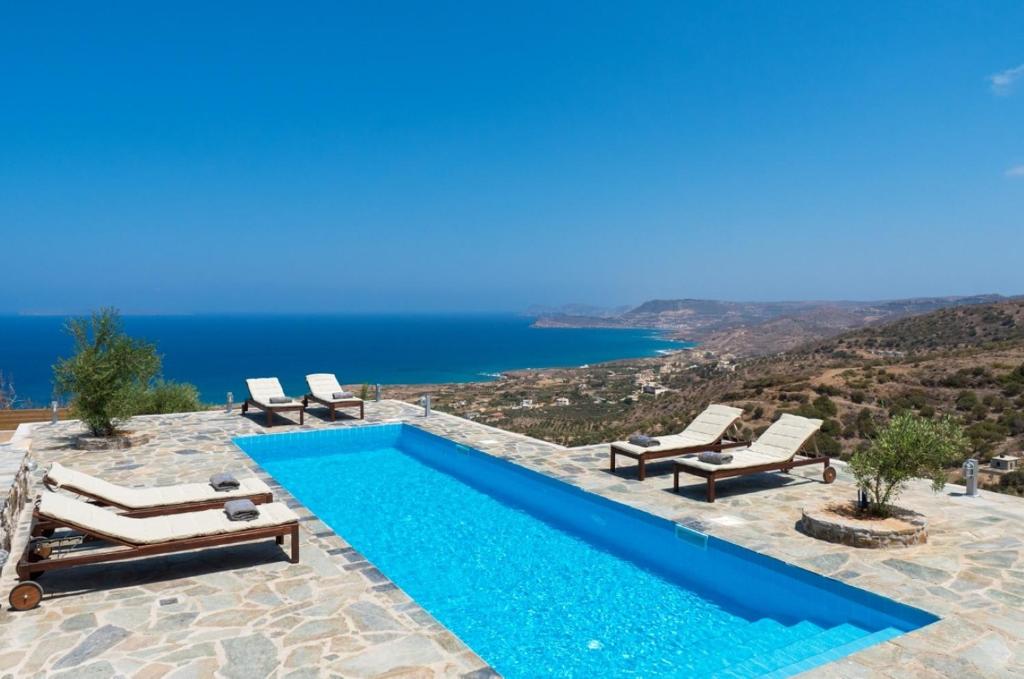 a swimming pool with a view of the ocean at Villa Isidora in Sitia