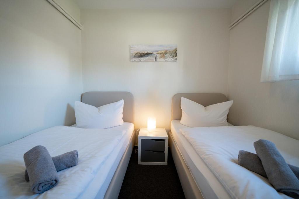 Postel nebo postele na pokoji v ubytování Haus Sonnenwinkel Bungalow 4