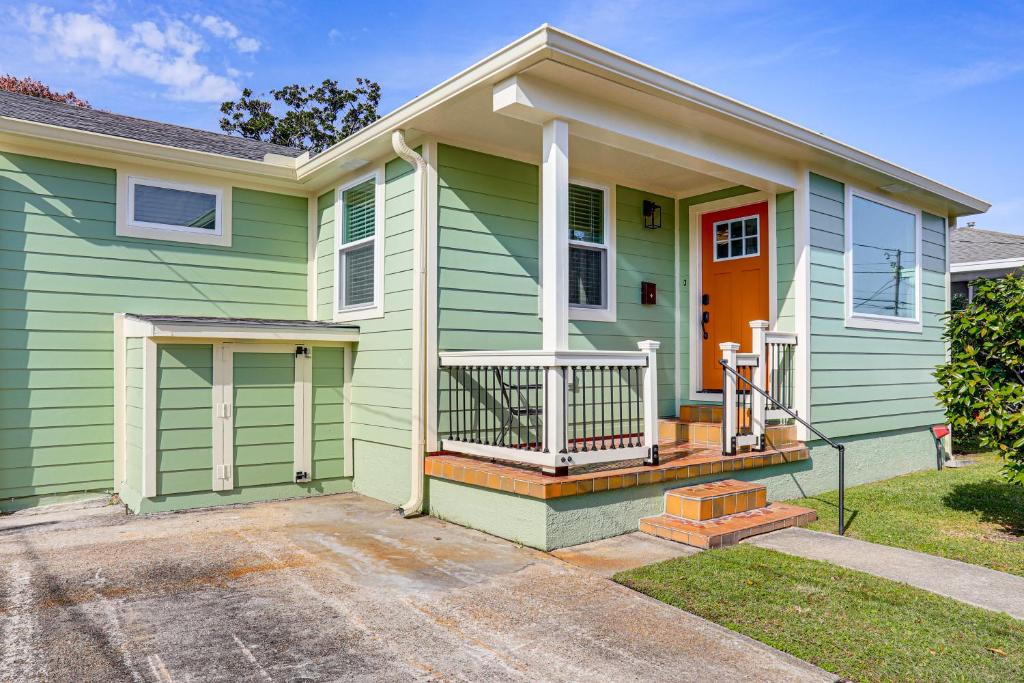 a green house with an orange door at 8 Mi to Dtwn New Orleans! Newly Renovated Home in Metairie