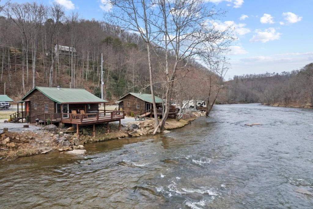 a cabin on the side of a river at Tuck River Magic - 6 Waterfront Homes, Fish, Hike, and Mountain Views! in Dillsboro