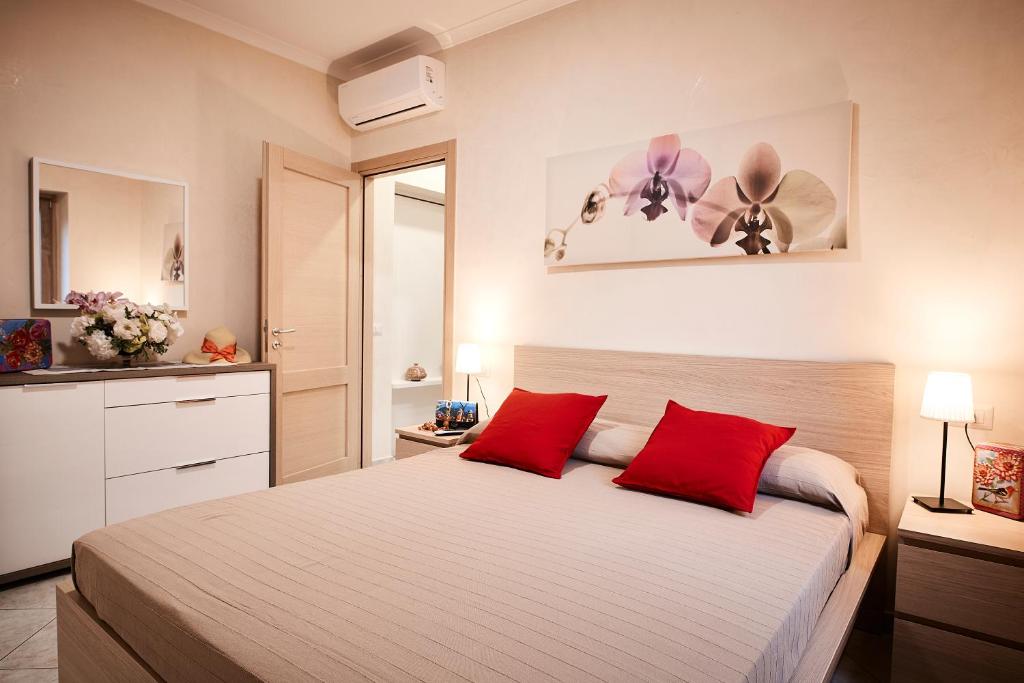 a bedroom with a large bed with red pillows at Casa Vacanze La Trinità in Ravello