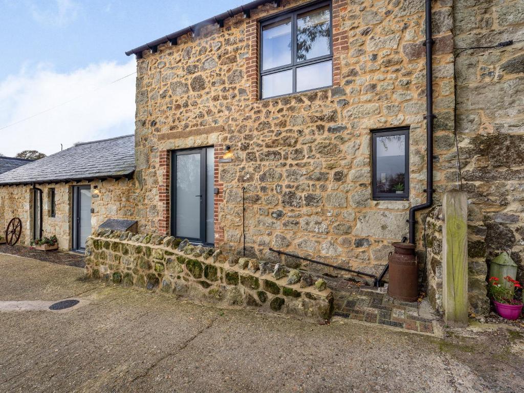 a stone house with windows on the side of it at The Hayloft-Uk34015 in Godshill