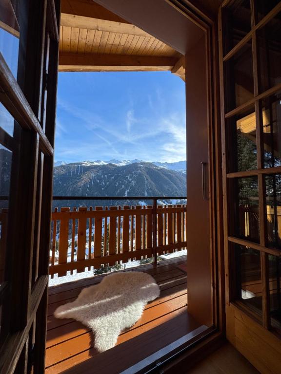 a view from a window of a balcony with a view at Chalet Famicha by Jolidi in Nendaz