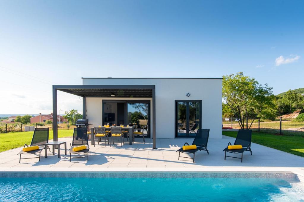 a villa with a swimming pool and a patio at Villa Lotta by Istrialux in Labin