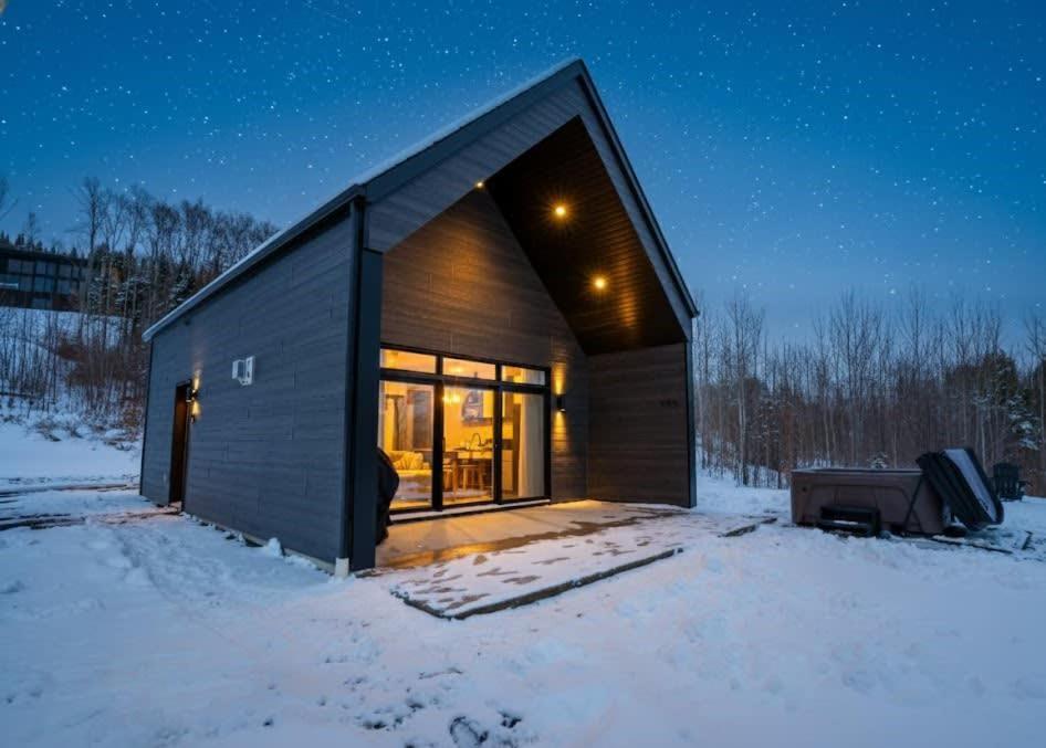 a small house in the snow at night at Modern Comfort - Spa - Mountain - Chalet ALBA in Saint Come