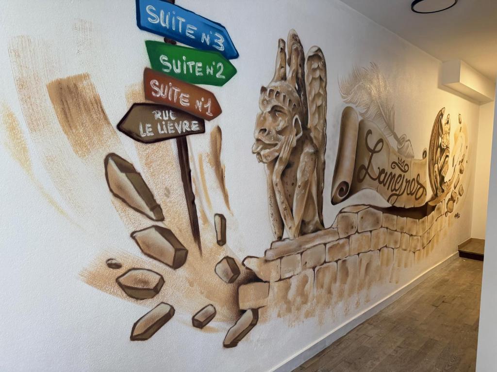 a wall with street signs and shoes on it at Suite 1- La Petite Auberge in Langres