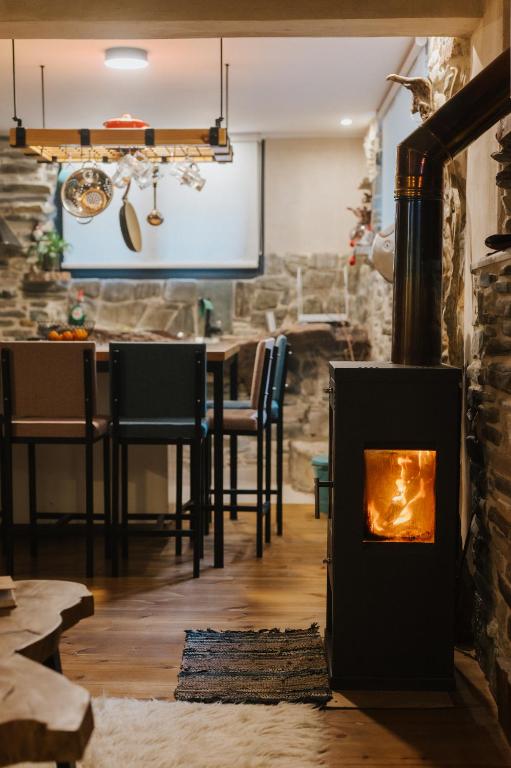 a living room with a fireplace and a table at Handmade semi basement in Ioannina