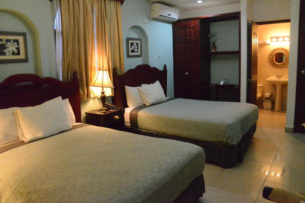 Ένα ή περισσότερα κρεβάτια σε δωμάτιο στο Hotel Aloha Managua