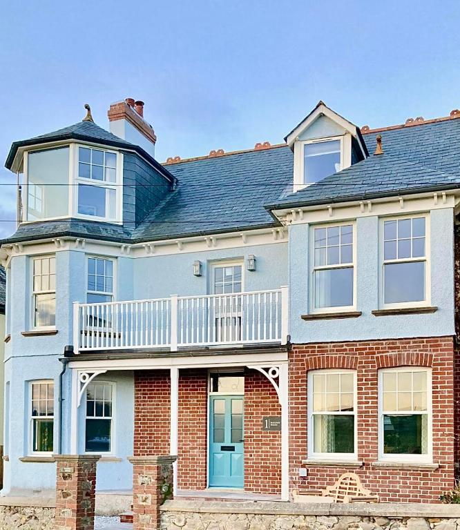 a large brick house with a balcony on it at 1 Bossiney House - Bude Cornwall in Bude
