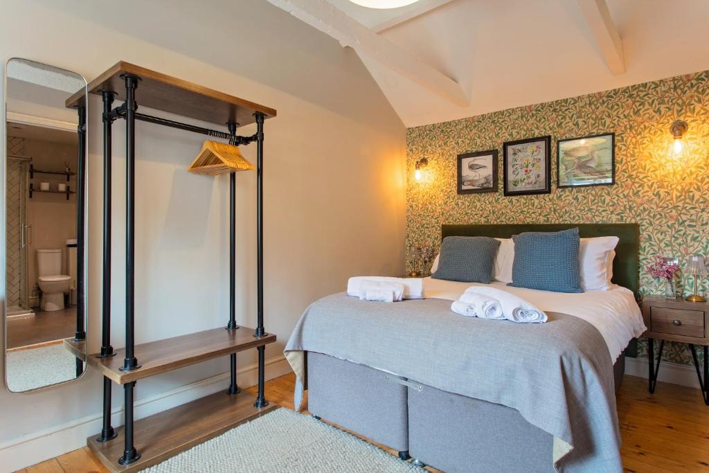 a bedroom with a bed with towels on it at The Three Swallows Cley in Cley next the Sea
