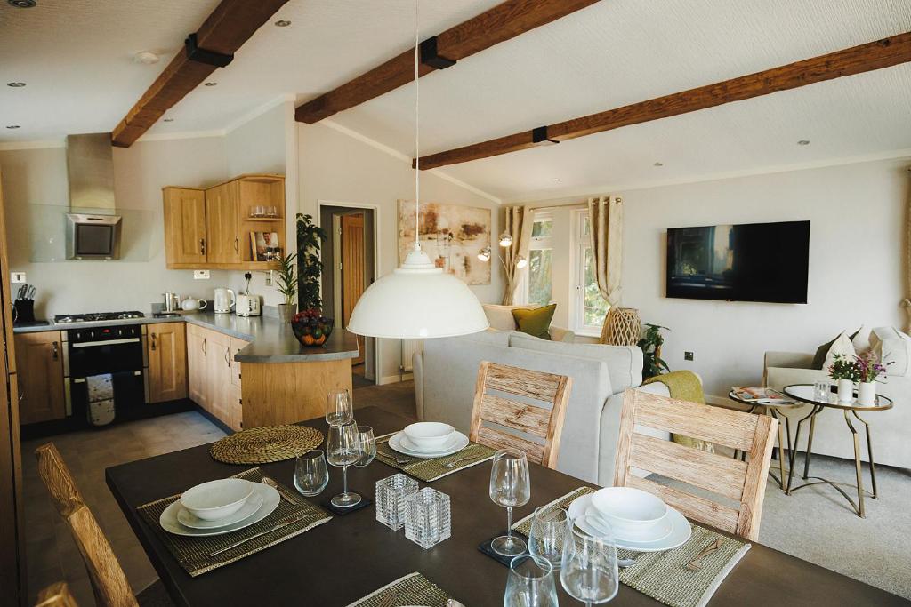 a kitchen and a living room with a dining table at Caer Rhun Hall Hotel in Conwy