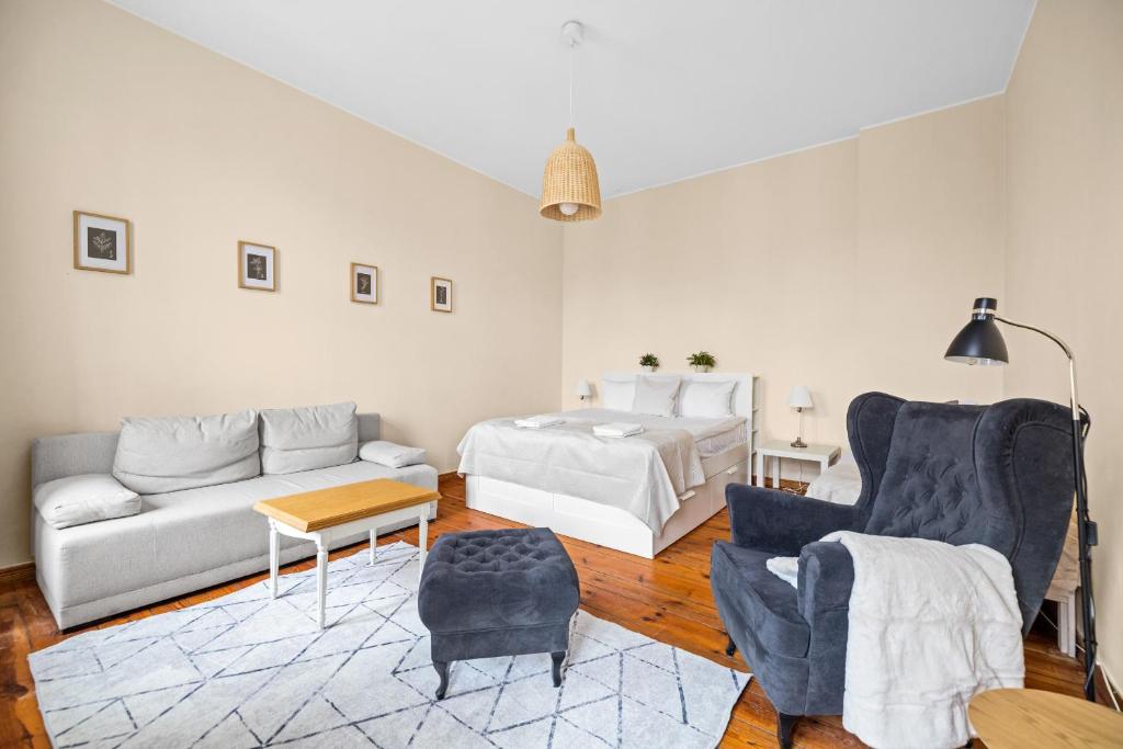 a living room with a bed and a couch at Riviera Residence Apartments in Sopot