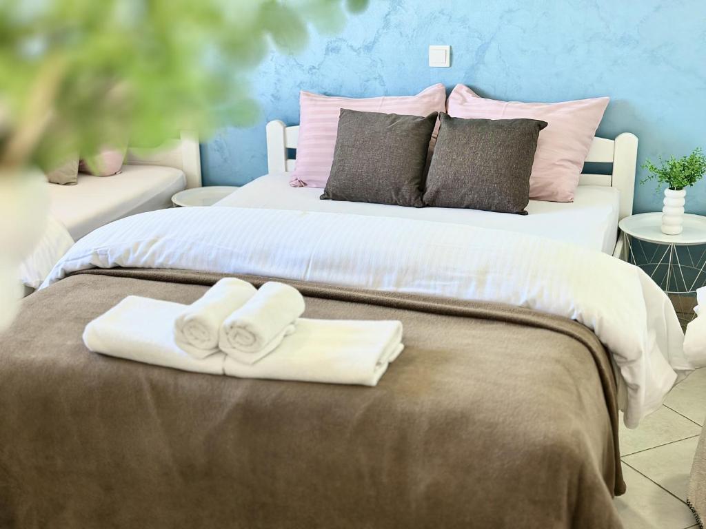 a bedroom with two towels on a bed at Zaliv Apartments in Tivat