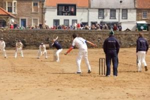 a group of baseball players playing a game on a field at Ingleside Cottage in Elie