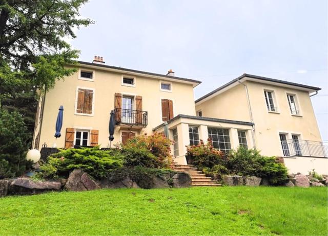 a large white house with stairs in a yard at Domaine de la Brême 