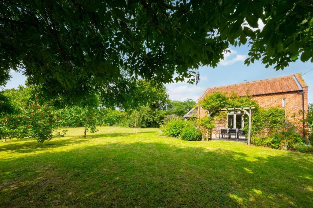 an old brick house with a large grass yard at 5 Bed in Guestwick oc-2199 in Guestwick