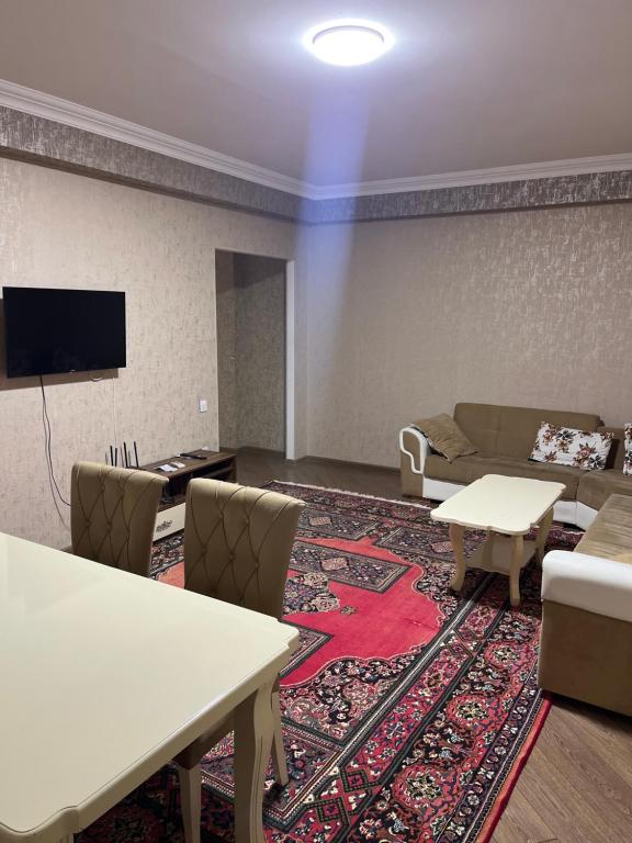 a living room with a couch and a table at Apartment city in Baku