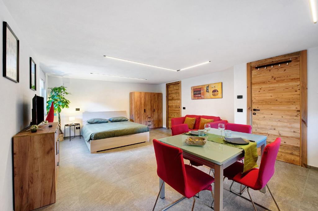 a living room with a bed and a table and chairs at La Pièce de Leo in Châtillon
