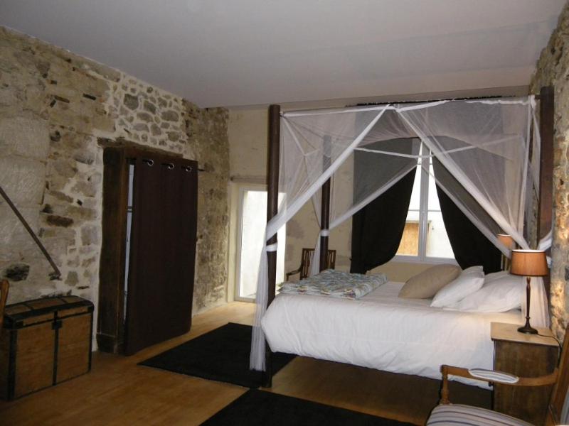 a bedroom with a bed with a canopy at Le MONSEG in La Celle-sous-Gouzon