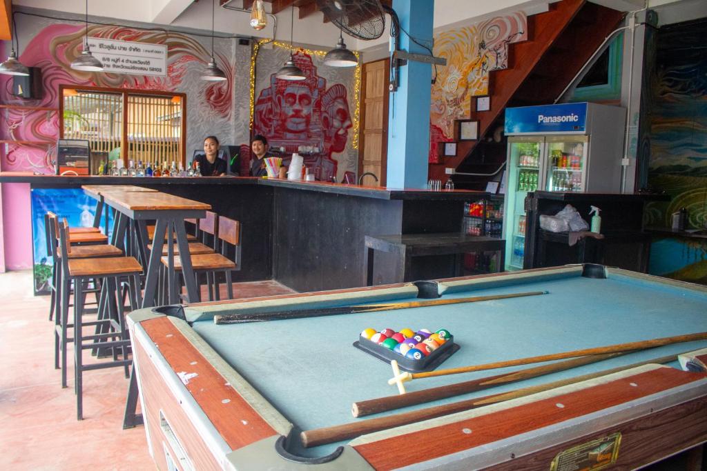 a pool table in a restaurant with a bar at Revolution Pai In Town in Pai