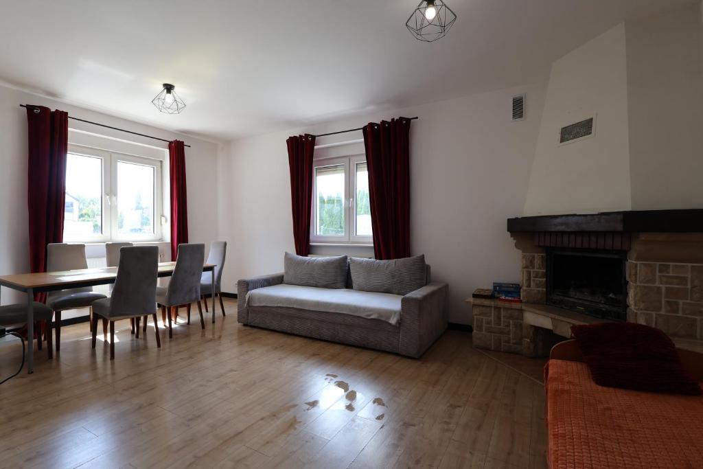 a living room with a couch and a table at Dom na wyłączność #Beskidzka FV PARKING IMPREZY dozwolone in Rzeszów