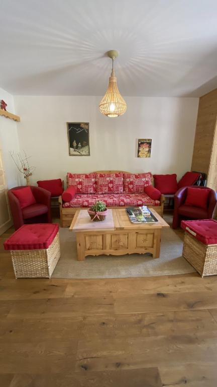 a living room with red couches and a coffee table at Chalet AIGUILLON RDC D in Le Lioran