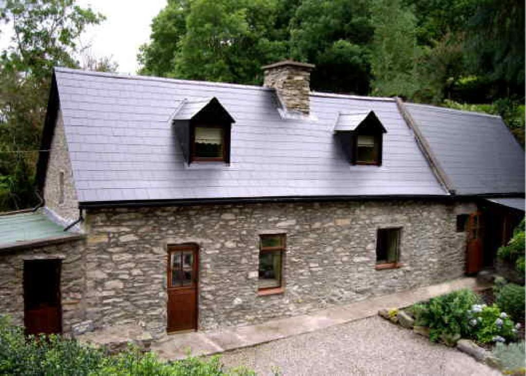 a stone house with windows and a roof at Stepping Stone Bed and Breakfast in Glencar