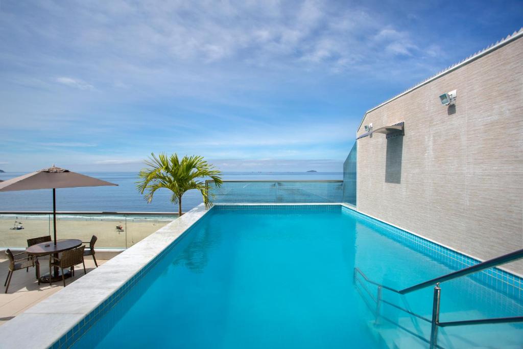 a swimming pool with a view of the beach at Hotel Atlantico Praia in Rio de Janeiro