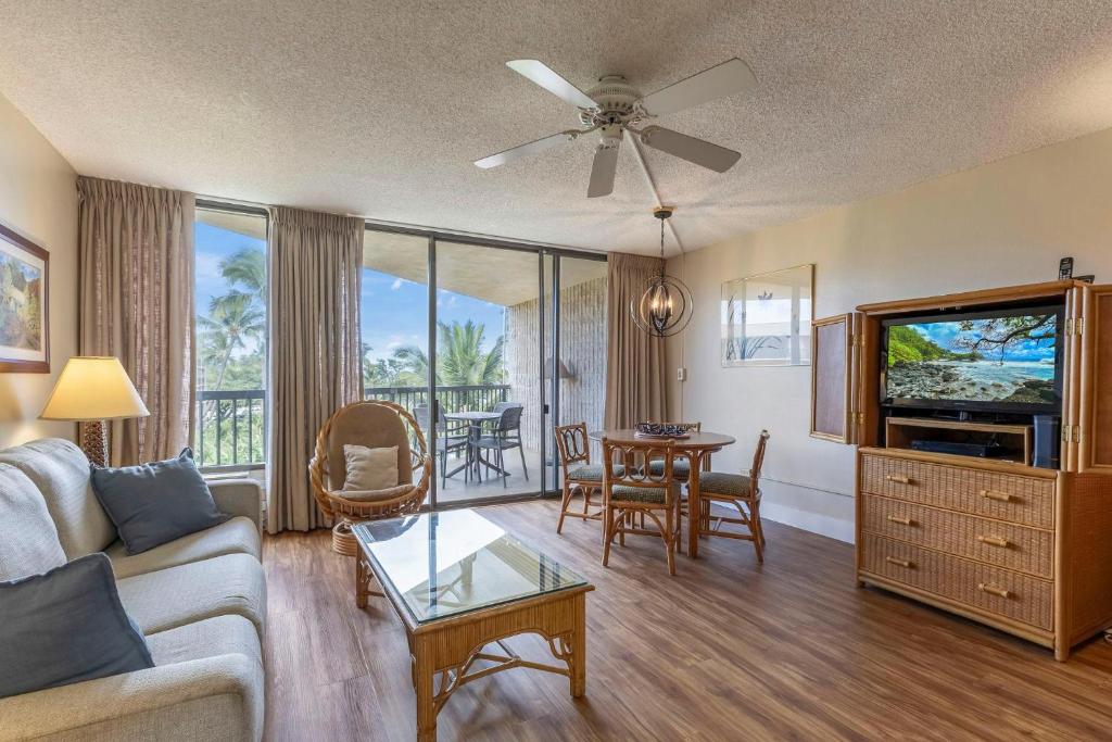 a living room with a couch and a table at Maui Sunset A413 in Kihei