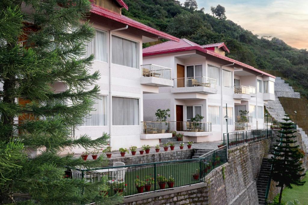 um edifício de apartamentos no lado de uma montanha em The Fern Surya Resort Kasauli Hills, Dharampur, Series by Marriott em Kasauli