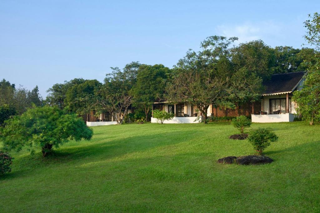 a house with a large yard in front of it at The Fern Samali Resort Dapoli, Series by Marriott in Dapoli