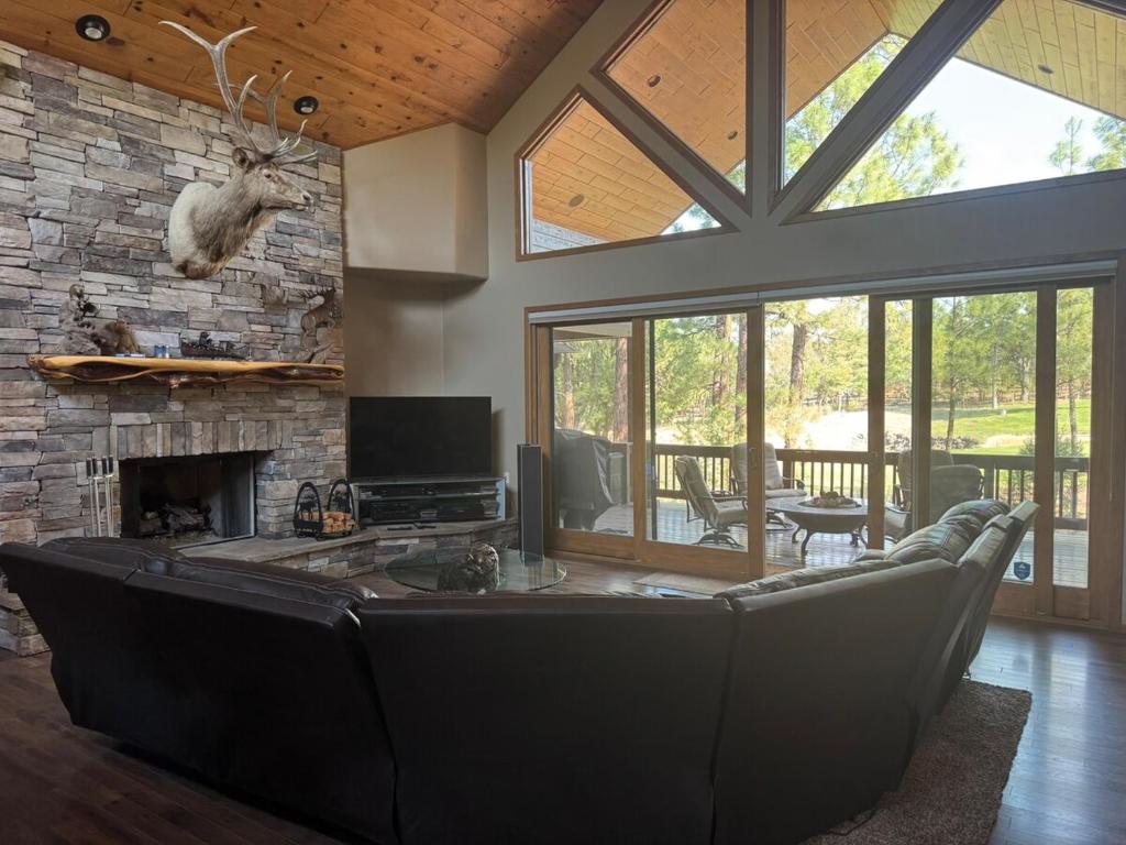 a living room with a couch and a fireplace at Torreon Getaway on the Greens with hot tub, 4 bedrooms, sleeps 10 in Show Low