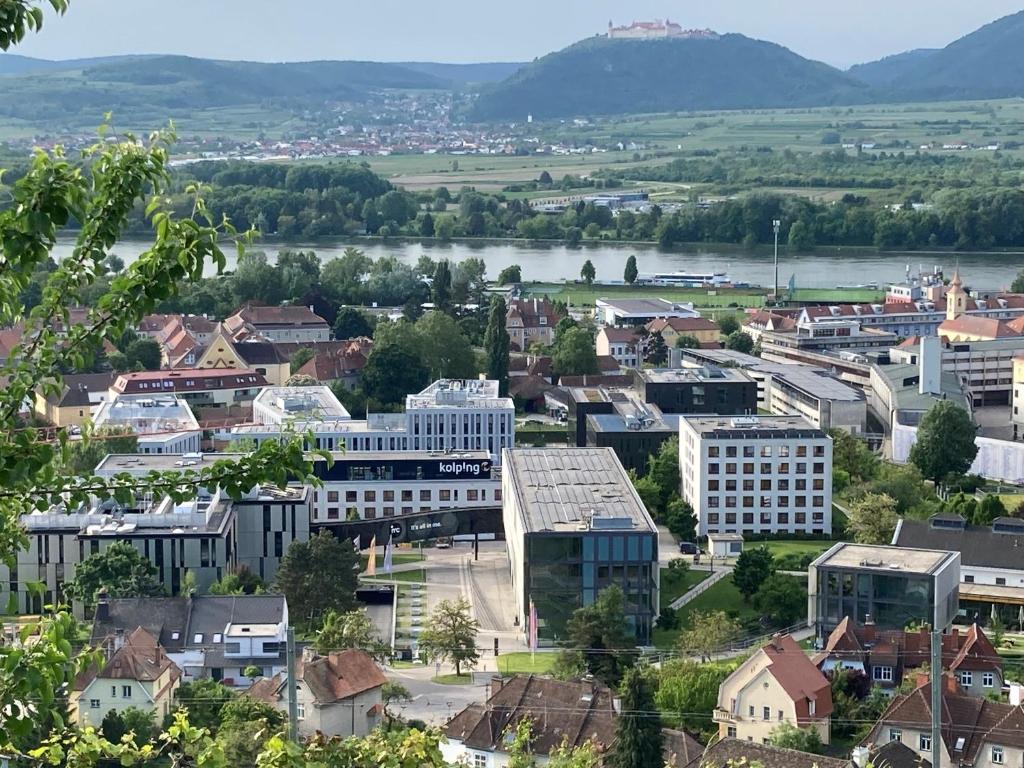 an overview of a city with a river and buildings at Kolping Campus Krems in Krems an der Donau