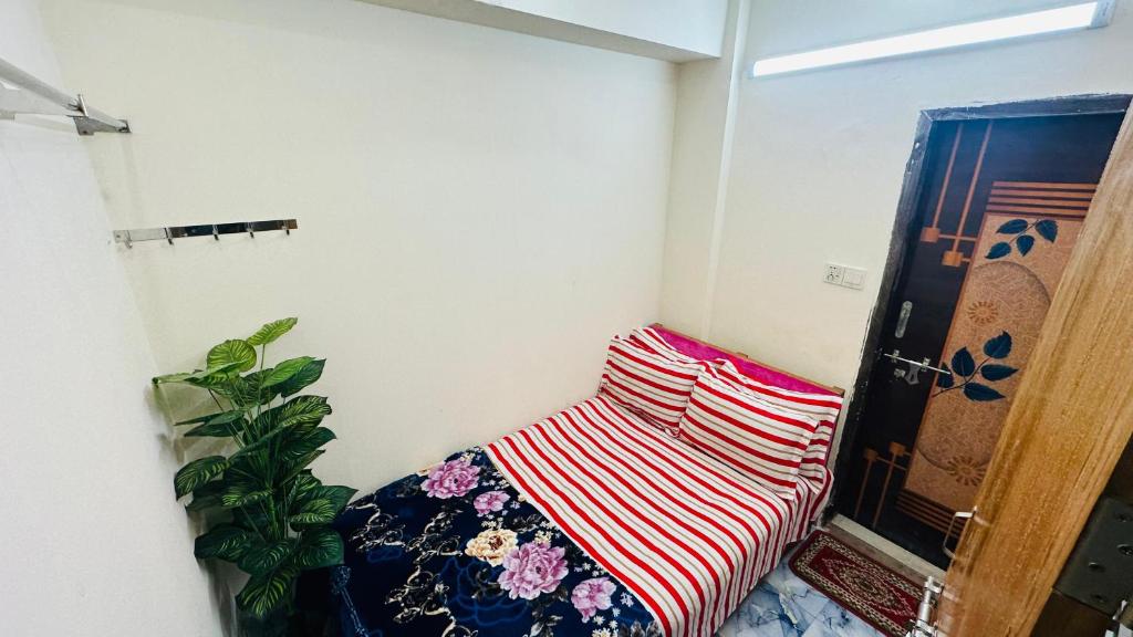 a room with a couch and a plant in it at Hotel Prime City Residential in Dhaka