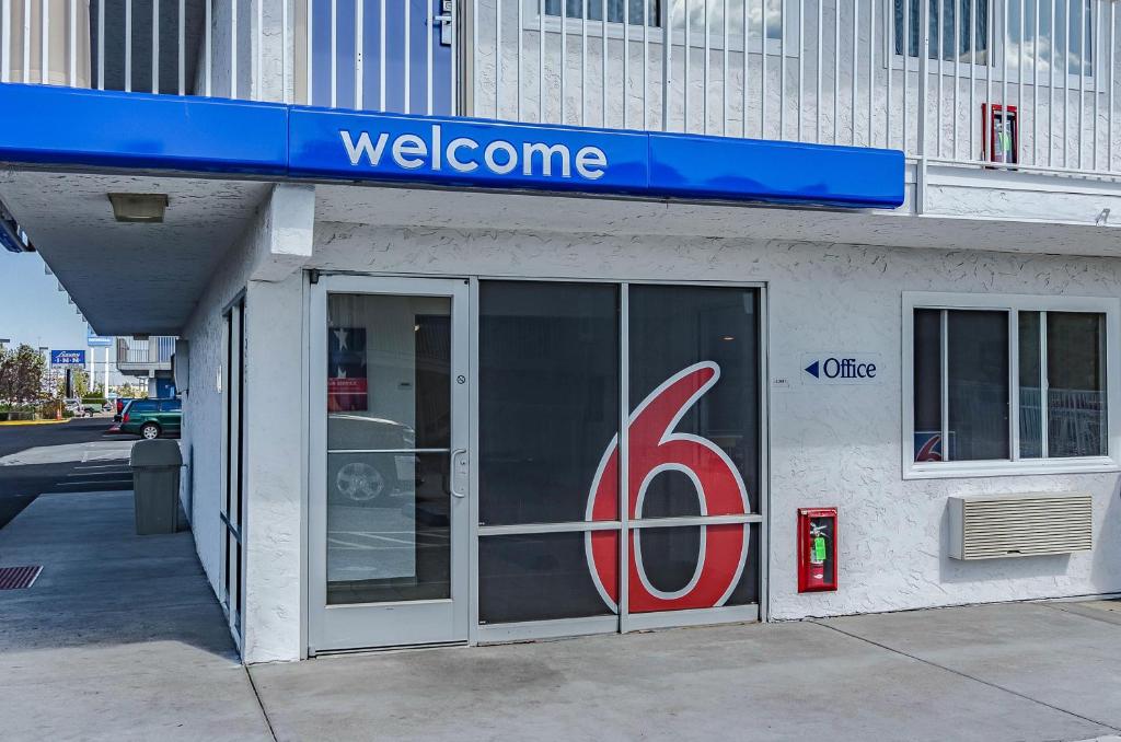 a store front with a door with the number six at Motel 6 Cheyenne, WY in Cheyenne