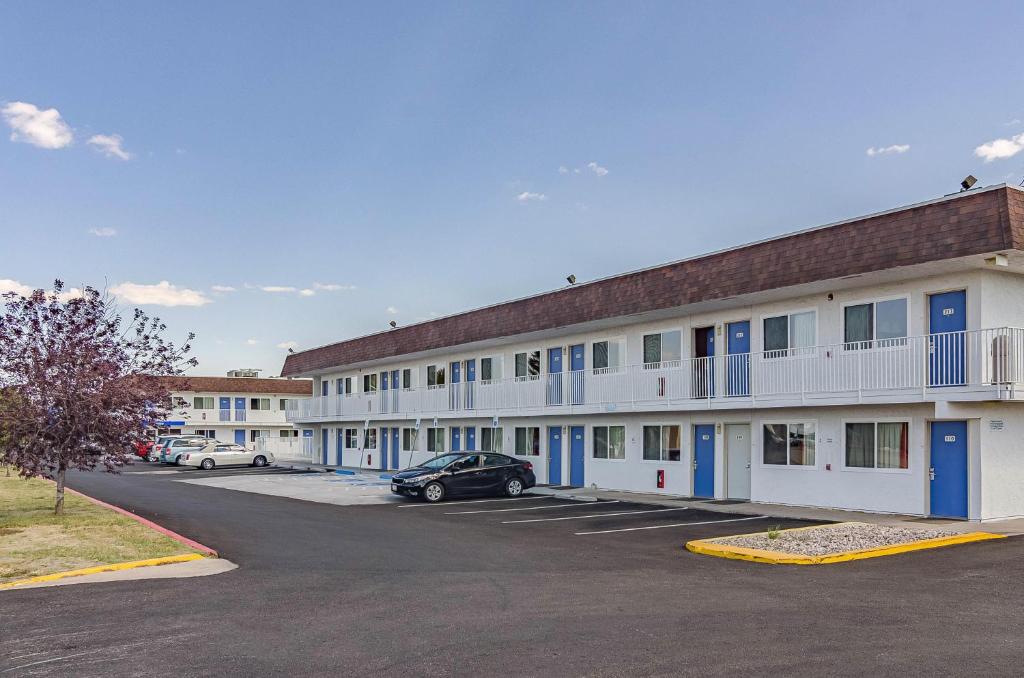 a large building with cars parked in a parking lot at Motel 6 Cheyenne, WY in Cheyenne