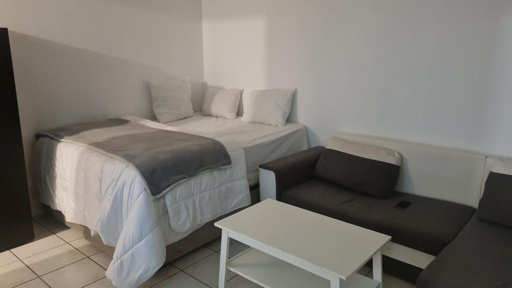 a small room with a bed and a couch at RELAX Privacy in Sarcelles