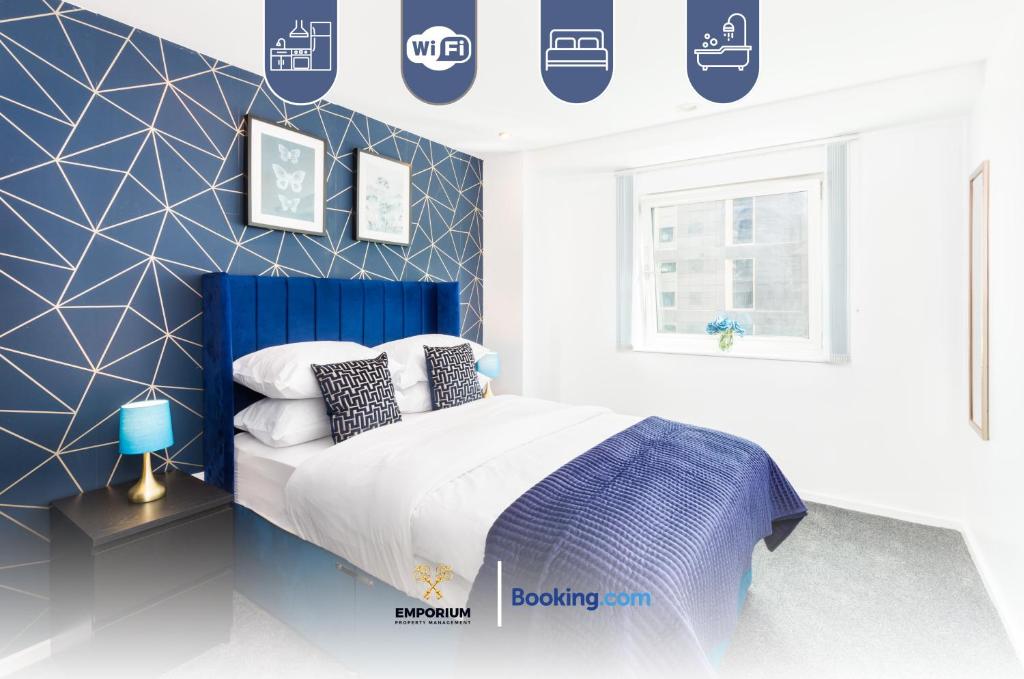 a blue and white bedroom with a bed and a window at Two Bedroom Flat By Emporium Property Management Short Lets & Serviced Accommodation Birmingham With Balcony & Close To Central Massplaza in Birmingham
