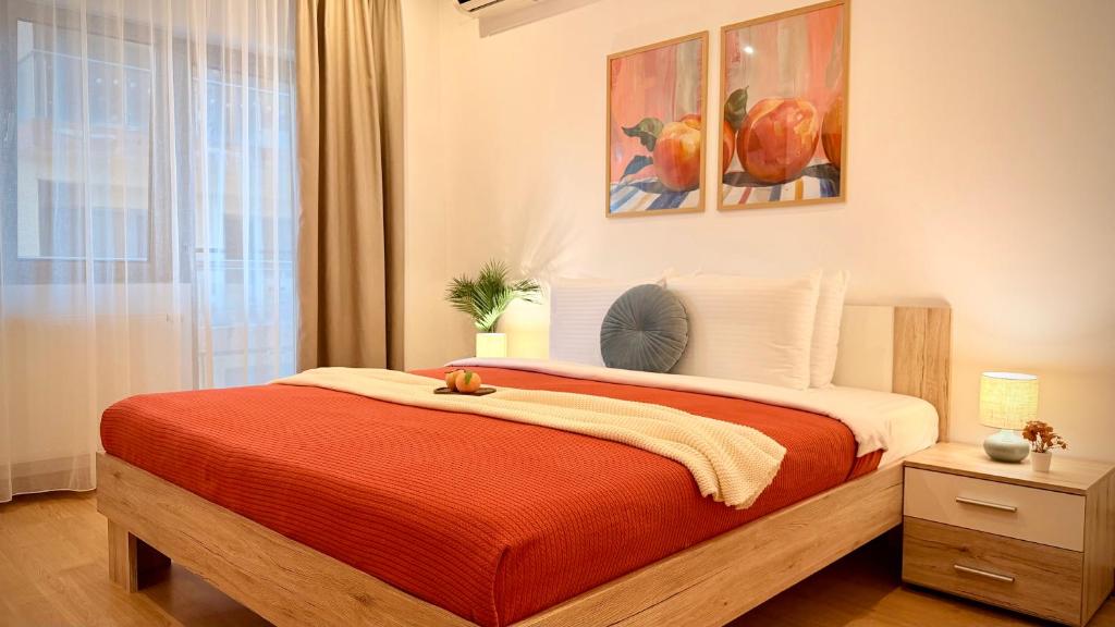 a bedroom with a large bed with a red blanket at Premium Stay - Spacious 3BR with Balcony in Bucharest