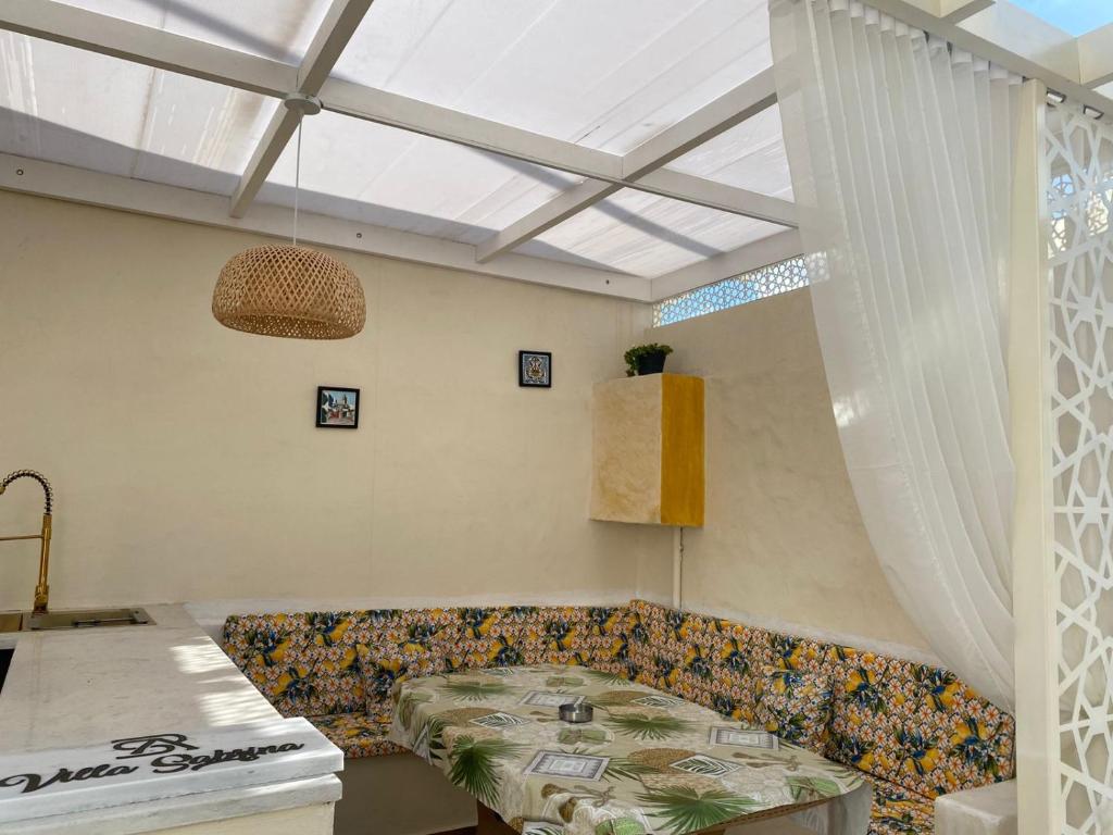 a living room with a couch and a table at Villa Sabrina in Awlād ‘Umar