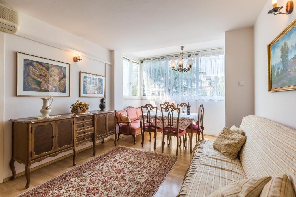 a living room with a table and a dining room at Vemar Apartment - Near the beach, Private parking in Dubrovnik