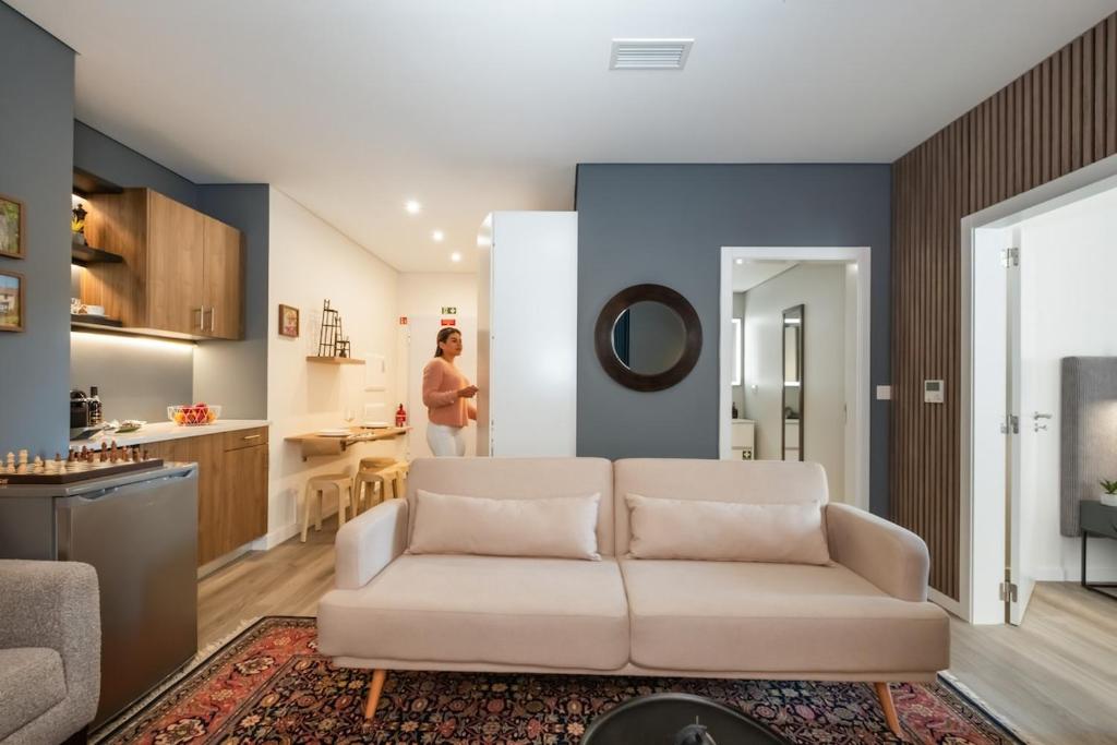 a living room with a white couch and a kitchen at Boutique in Funchal