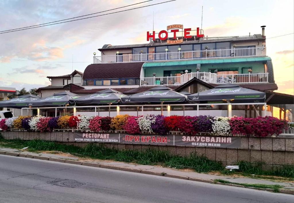 a hotel with a lot of flowers in front of it at Brani Family Hotel in Ruse