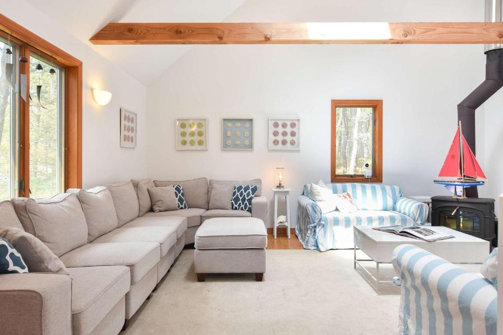 a living room with a couch and a chair at 15 Min Walk to Beach w Kayaks in Wellfleet