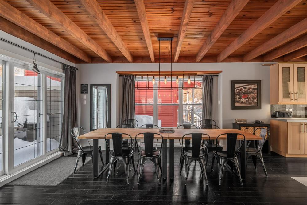 a dining room with a table and chairs at Chalet 9028 Chemin des Alpages by Les Chalets Alpins in Stoneham