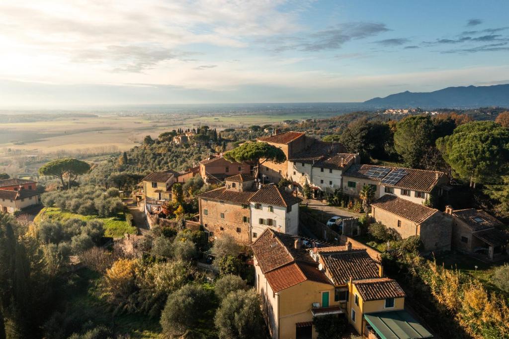 an aerial view of a village with houses and trees at Pura Apartment Hill View Stay near Peccioli & Lajatico in Palaia